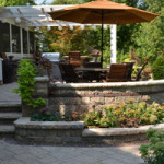 Hardscaping: multi-level stone patio with walls, planting areas, stairs and more - Greener Horizon