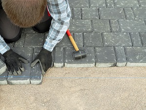 Paver laying driveway pavement out of concrete pavement blocks