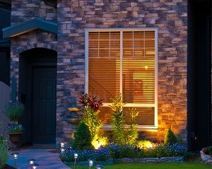 Exterior lighting of an entrance of a house at dusk.