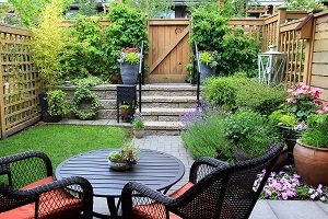 Small garden with patio furniture amidst blooming lavender. 